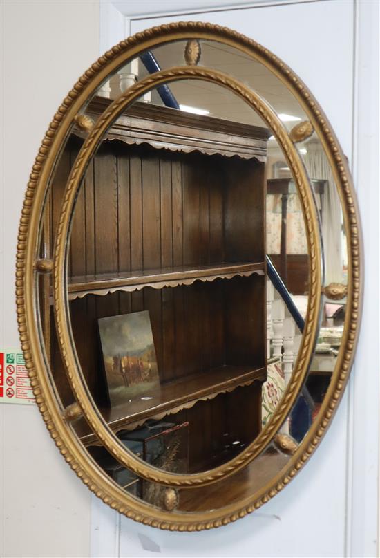 A gilt frame oval mirror H.82cm